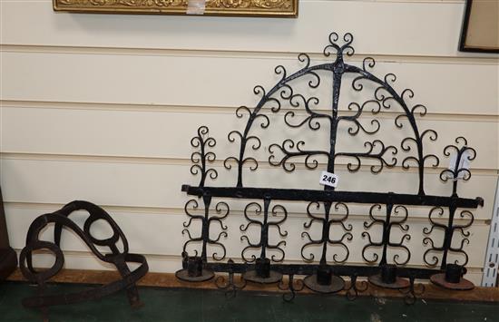 A 17th century wrought iron wall sconce, an iron guard and a wrought iron roasting hanger